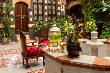 Interior of luxury hotel in oriental style with living plants and fountain in the lobby - obrazy, fototapety, plakaty