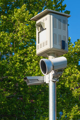 Traffic speed camera on post on sunny spring day, vertical image