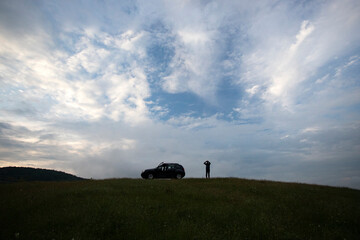 Active turism. mountain activities concept. Silhouette of a man near his off-road car.