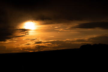 Orange sunset with dramatic clouds.