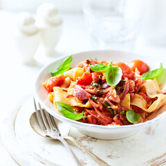 Pappardelle Pasta with Vegetables and fresh Basil on bright wooden Background