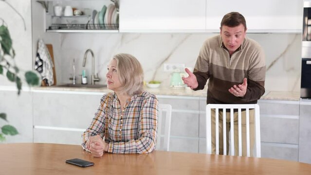 Family quarrel, son blaming mother, both are upset, angry and disappointed. Family quarrel of mother and son. High quality 4k footage