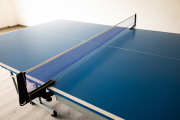 Blue indoor table tennis table. Indoor sports. Ping Pong Table. Healthy lifestyle concept.