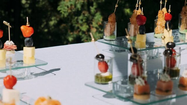 snacks on a buffet table outside on a sunny day