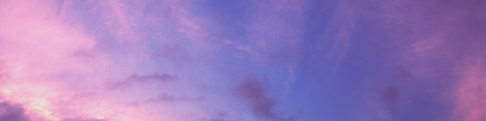 Horizontal panorama of colorful cloudy sky at sunset. Sky texture, abstract nature background