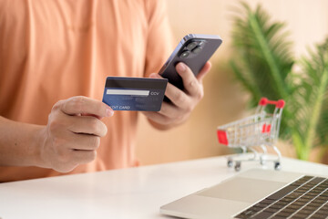 Online payment,Man's hands holding a credit card and using smart phone for online shopping