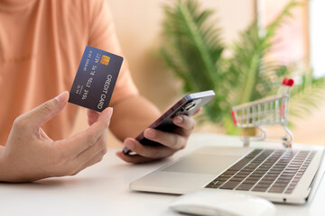 Online payment,Man's hands holding a credit card and using smart phone for online shopping