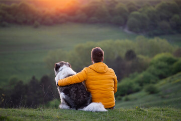Happy dog and man playing outdoor