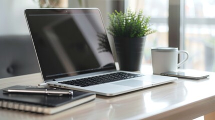 Fototapeta premium a sleek laptop sits atop a clean desk, bathed in natural light, a cup of coffee, offering a moment of refreshment
