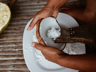 people are using grated coconut to make a tool for coconut milk as ingredients in cooking