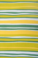 Striped fabric with yellow and green stripes. The stripes are of different widths and are arranged...