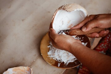 people are using grated coconut to make a tool for coconut milk as ingredients in cooking