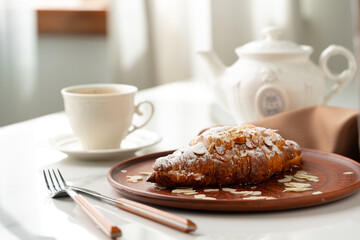 Almond Croissant on clay plate close up