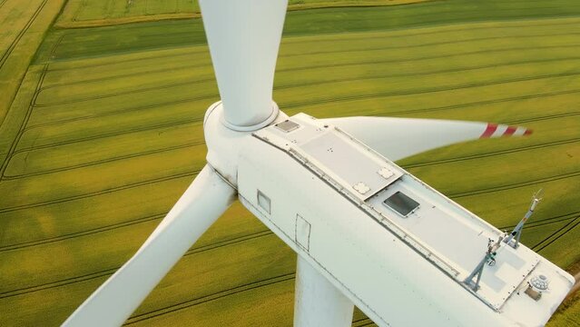 Windmill Farm From Drone. Cinematic aerial view large wind turbines producing clean sustainable energy. Rotating blades generate clean electric power