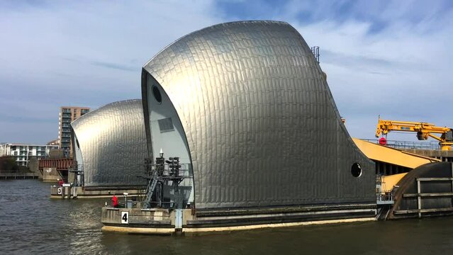 London Thames Barrier in Woolwich, near Greenwich. Cruising past on a sunny day. Retractable flood water barrier.