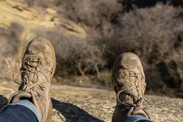 A Serene Pause: Hiking Boots Resting on Rock