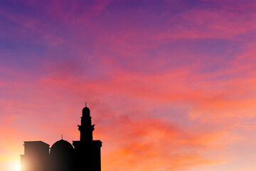 The silhouette of a mosque in sunset blurred background