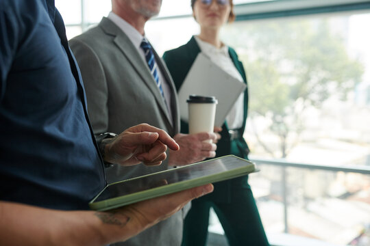 Cropped image of businessman checking schedule on tablet