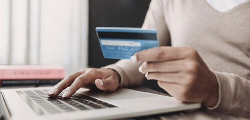 Woman using laptop computer with credit card making online order, banner. Business, online...