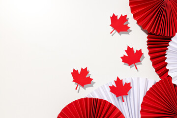 Red paper maple leaves with decorations on a light background