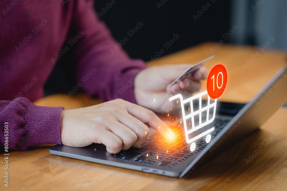 Poster customer uses a laptop computer to register through a credit card to make online purchases. business