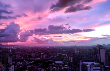 Fototapeta premium pink and purple clouds in an urban landscape, view from above