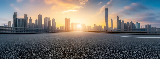 Empty asphalt road with city skyline background at sunset. Panorama view of empty black top surface for car advertising and product display presentation, banner