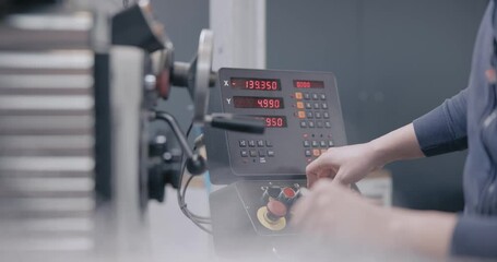 Hands of man controlling milling machine