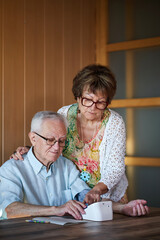 A senior couple taking blood pressure at home