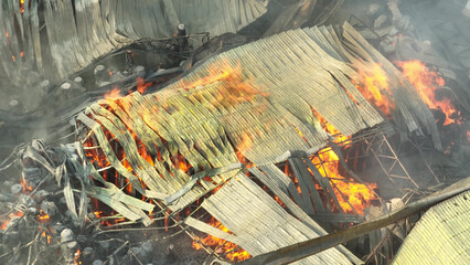 A raging industrial fire devours metal debris, its flames licking hungrily at the structure....