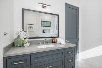 Gray bathroom sink and shower stall in a modern new construction home in Los Angeles