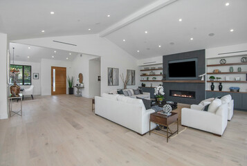 Spacious living room with white sofas in a modern new construction home in Los Angeles