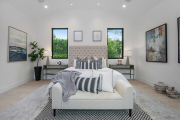 Bedroom with a white bed in a modern new construction home in Los Angeles