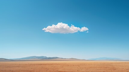 A clear blue sky with a single, solitary cloud drifting by.