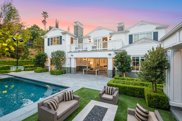 Large pool in front of a white house in Encino, California