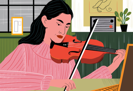 Woman learning violin through online tutorial at home