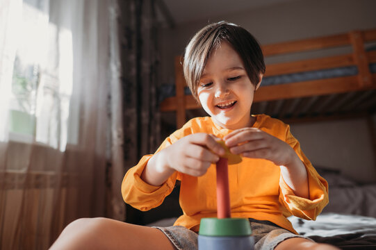 Happy boy playing with educational game at home