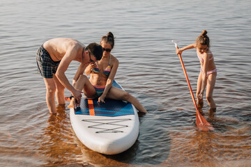 Family enjoying water sport on sunny day in sea