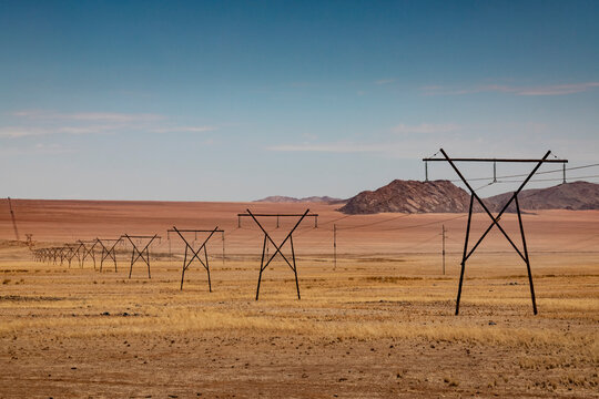 Namibia, Row of electricity pylons across desert area