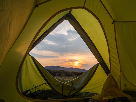 UK, Scotland, Sun rising over Cairngorm Mountains seen from inside of pitched tent
