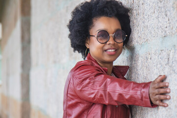 retro afro woman with vintage glasses posing on the wall
