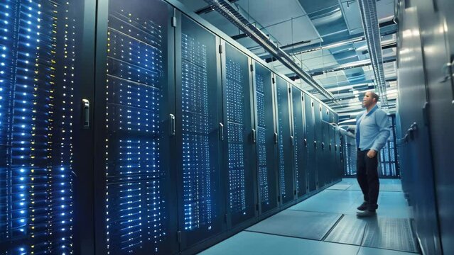 A man stands in front of a server in a busy data center, surrounded by rows of computer equipment and cables, A sleek, modern data center with technicians at work