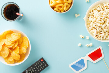 Dive into a home cinema adventure: top view of popcorn, crisps, soda, and streaming remote....