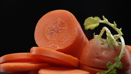 Macrography, sliced carrots take center stage with black background, creating a striking visual...