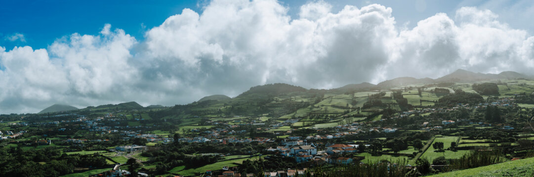 Portugal, Azores, Capelas, Summer clouds over village on San Miguel island