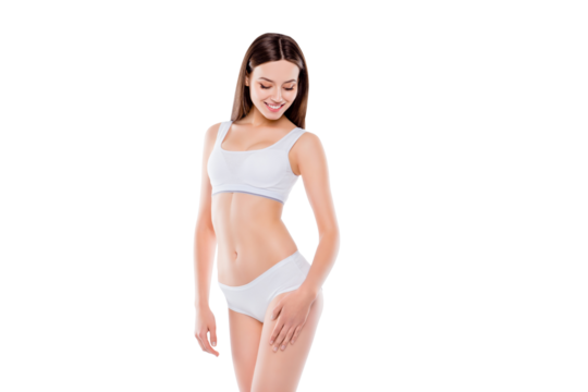 Portrait of thin sportive woman with perfect body in white cotton underwear bikini isolated over white background touching hips enjoying smooth ideal leg's skin