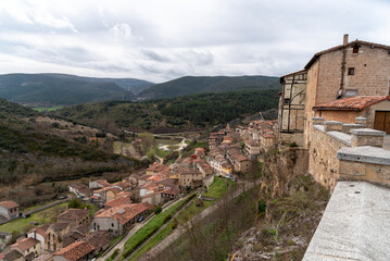 Fototapeta na wymiar Panoramic view of the touristic village of Frías in the province of Burgos, situated on a hill with small houses of stone, wood and brick.
