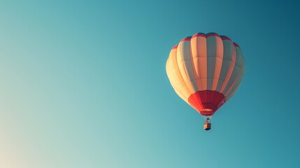 Fototapeta premium A clear blue sky with a single hot air balloon floating peacefully.