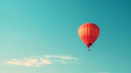 Naklejka premium A clear blue sky with a single hot air balloon floating peacefully.