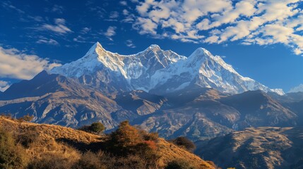 Breathtaking panoramic view of the majestic snow-capped mountain range in the high altitude wilderness. Surrounded by clear blue skies and untouched natural landscape